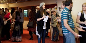 People milling around the foyer waiting to go into the Nuffield Busy Foyer by bar