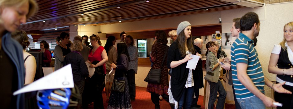 People milling around the foyer waiting to go into the Nuffield